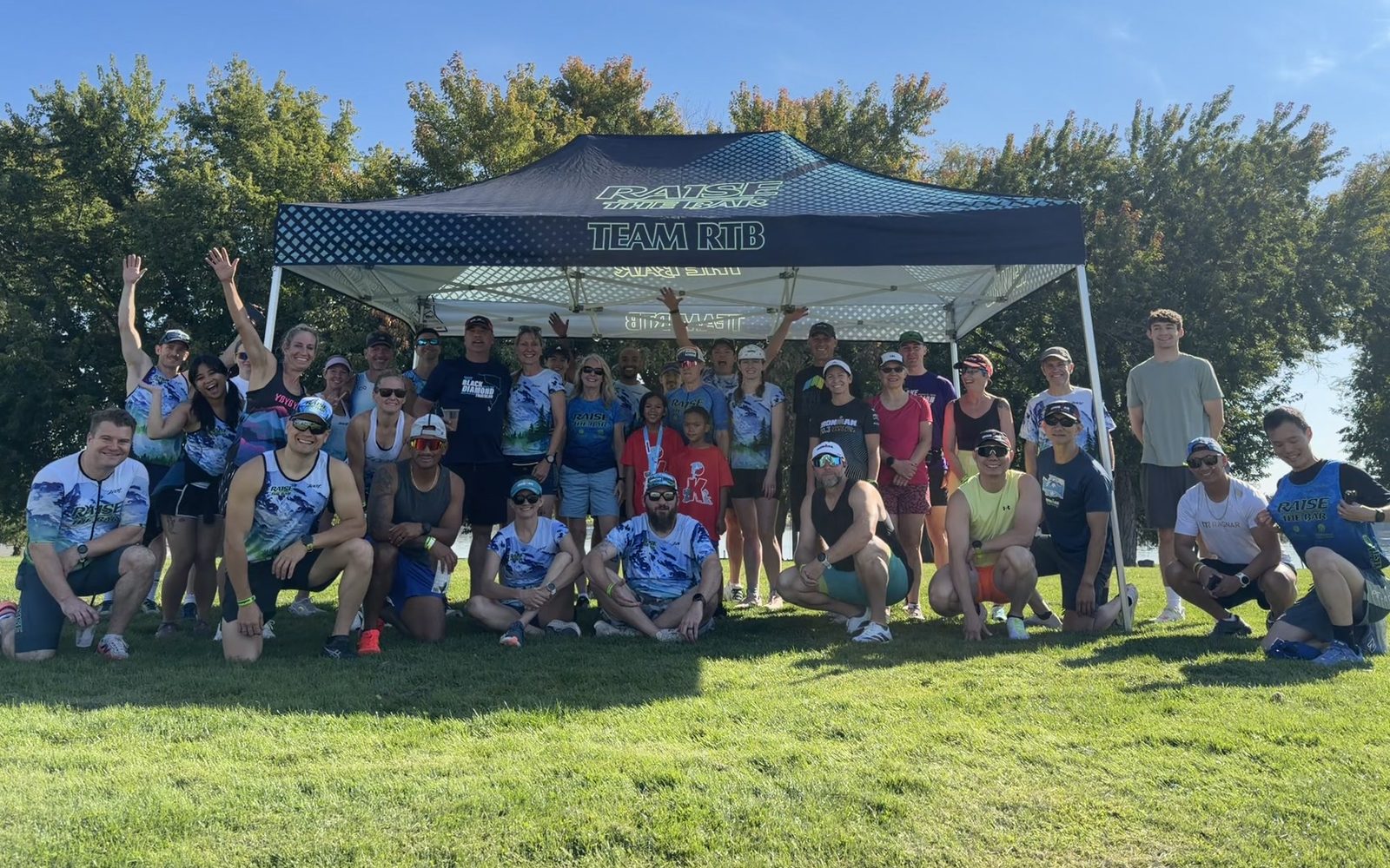 RTB athletes and friends under the Team RTB tent at the IRONMAN 70.3 Washington Tri-Cities shakeout run